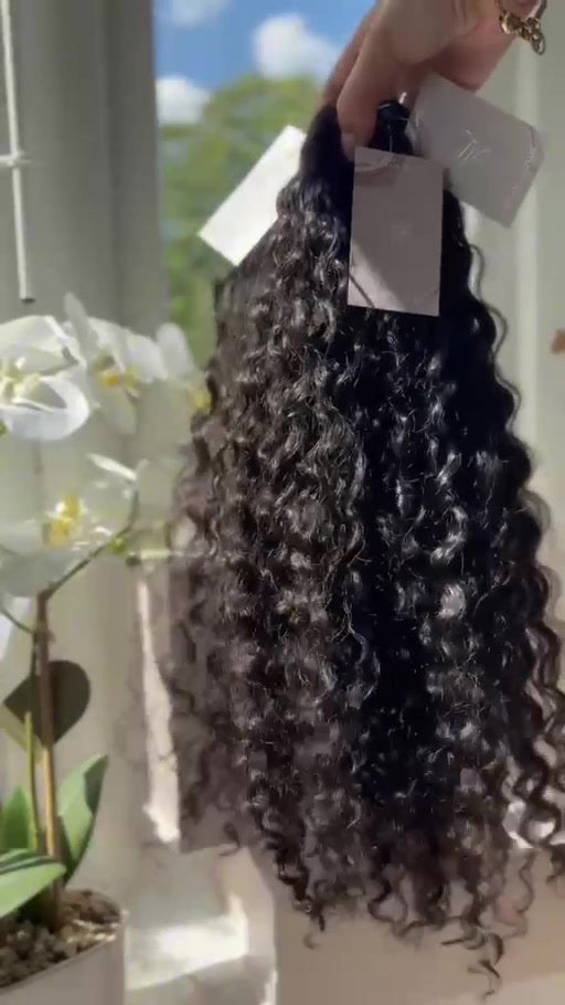 Aluna Luxe hair bundles held in daylight